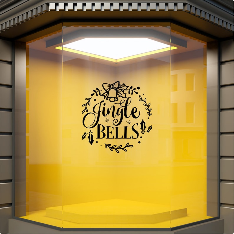 Black Jingle Bells Christmas decal displayed on a yellow shop window