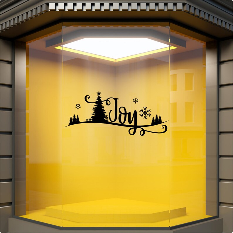 Black Joy Christmas scene window sticker on a yellow shopfront window