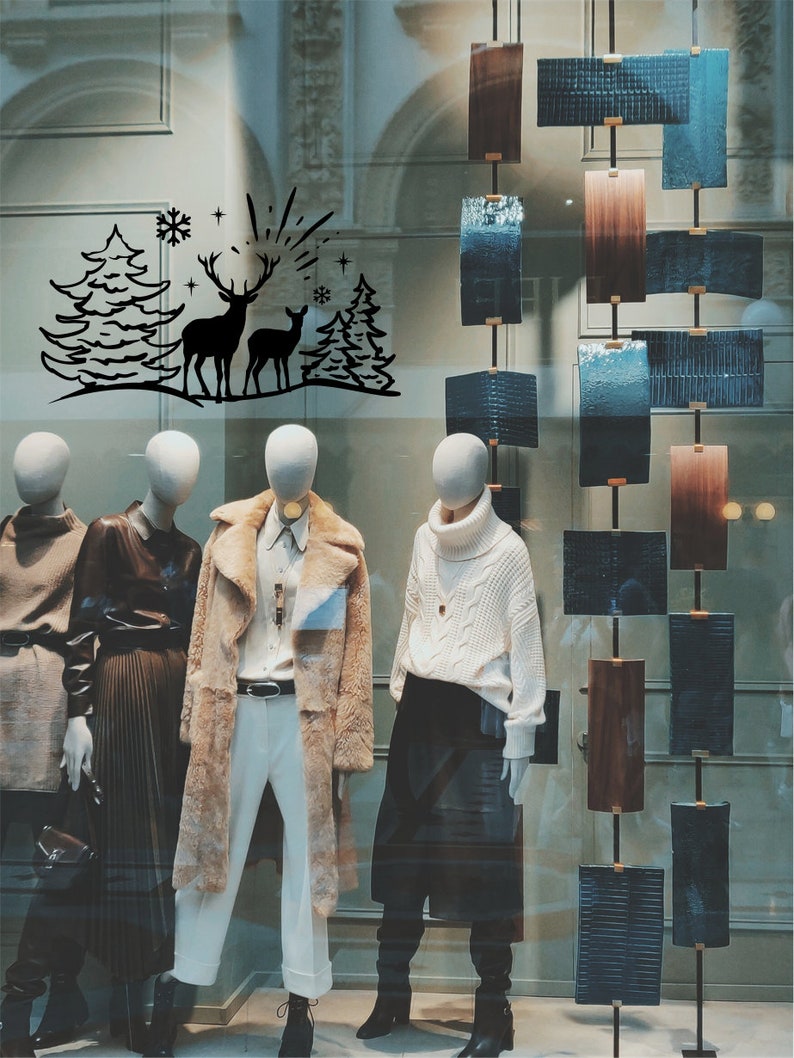 Black reindeer woodland scene vinyl decal on a Christmas shop window
