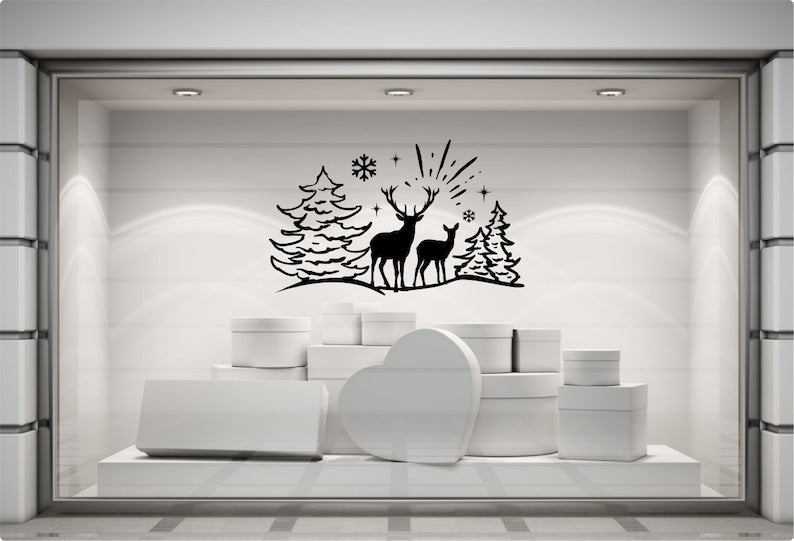Reindeer and pine tree festive vinyl decal on a modern grey shop display