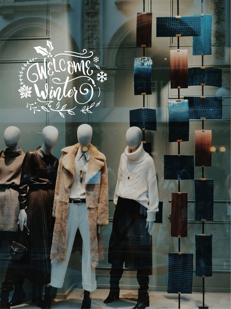 Welcome Winter Christmas window sticker on a festive shop display