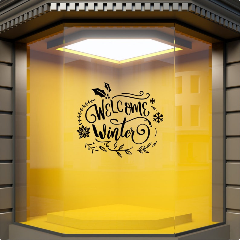 Welcome Winter festive vinyl decal displayed on a yellow shop window