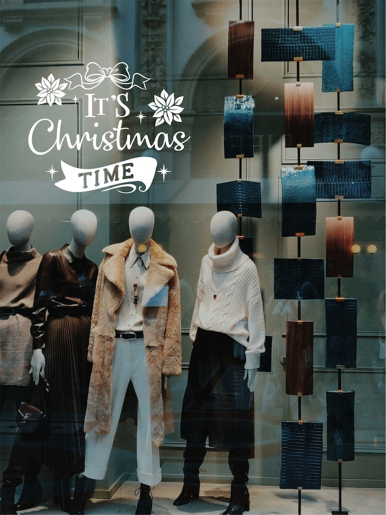 It's Christmas Time Christmas window sticker on a festive shop display