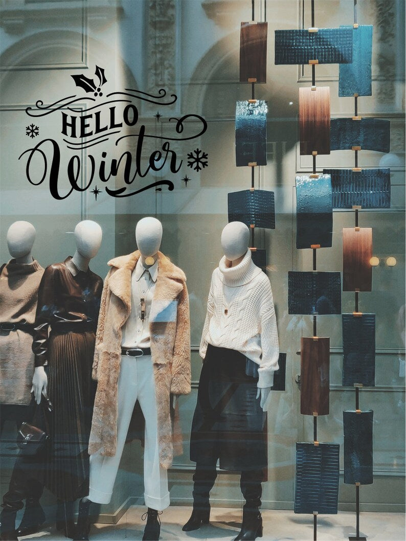 Hello Winter festive window sticker shown on a shop front