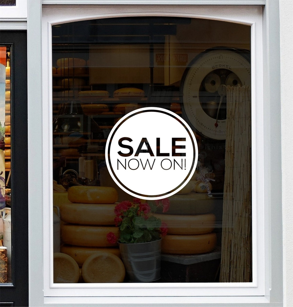 Sale Now On Shop Window Sticker displayed on a storefront glass pane