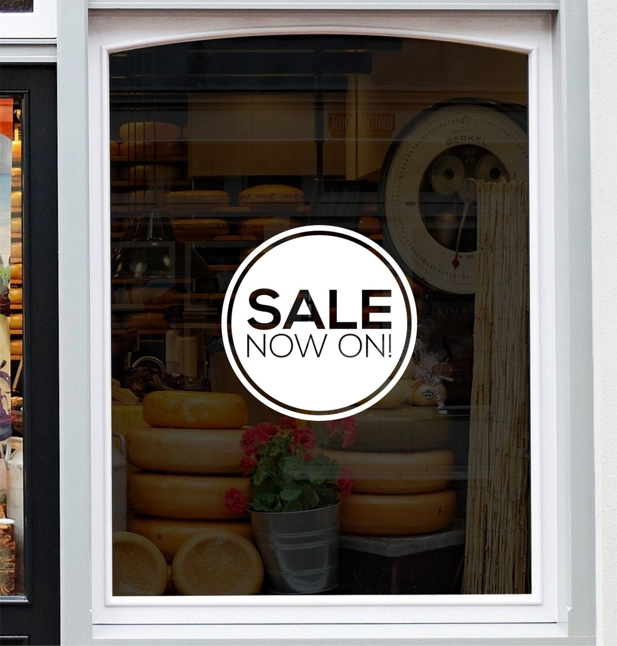 Sale Now On Shop Window Sticker displayed on a storefront glass pane