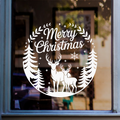 White Merry Christmas window decal featuring two deer, pine trees, and snowflakes, displayed on a glass window.