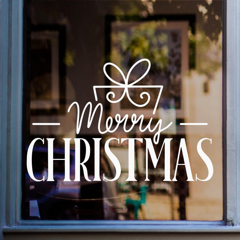 Merry Christmas window decal featuring elegant festive lettering with a decorative ribbon bow in white vinyl