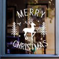 Merry Christmas white vinyl window sticker featuring a reindeer, fir trees, stars and snowflakes displayed on glass.