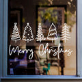 White Merry Christmas window sticker featuring five decorative Christmas trees displayed on a glass window.