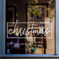 White Merry Christmas window sticker with modern handwritten lettering and a minimal rectangular border displayed on glass.