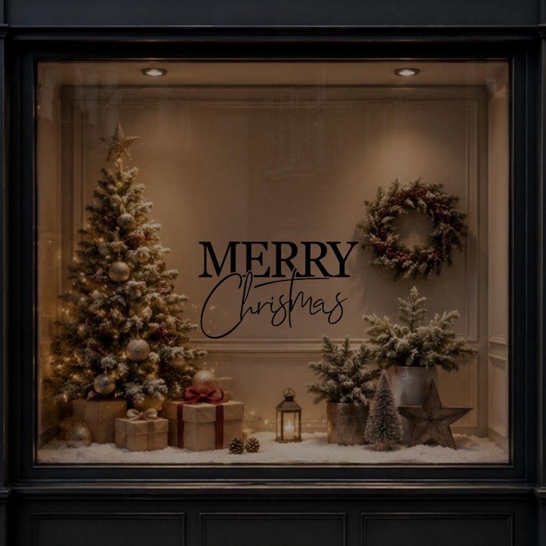 White Merry Christmas window sticker displayed on dark glass with Christmas decorations in the background.
