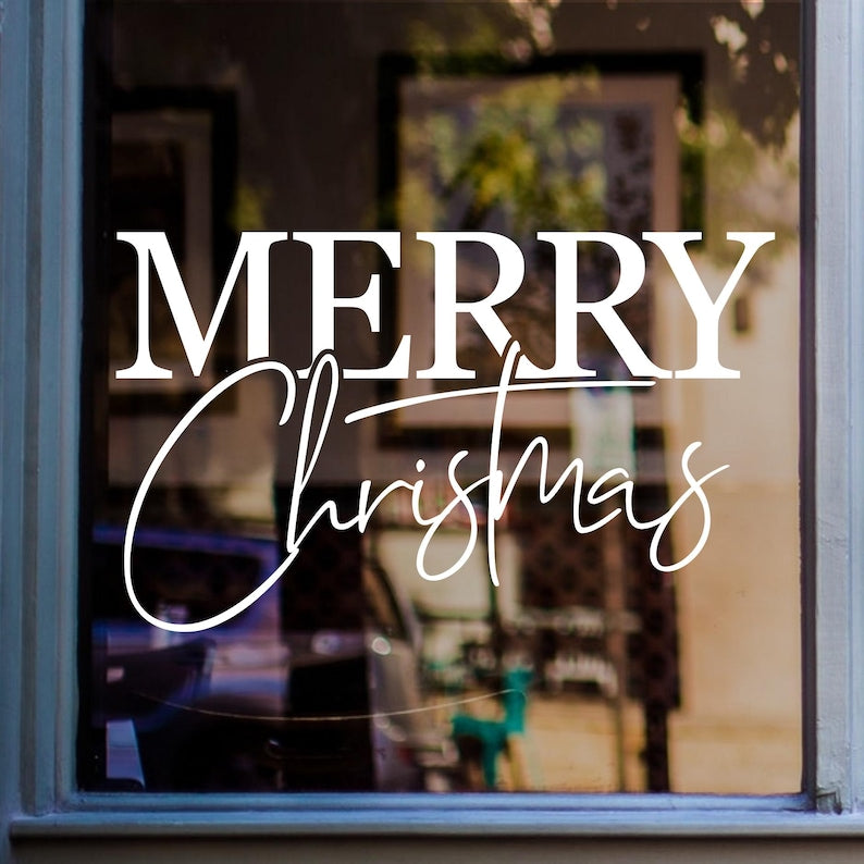 Merry Christmas window sticker in white vinyl displayed on a home window as festive Christmas decor.