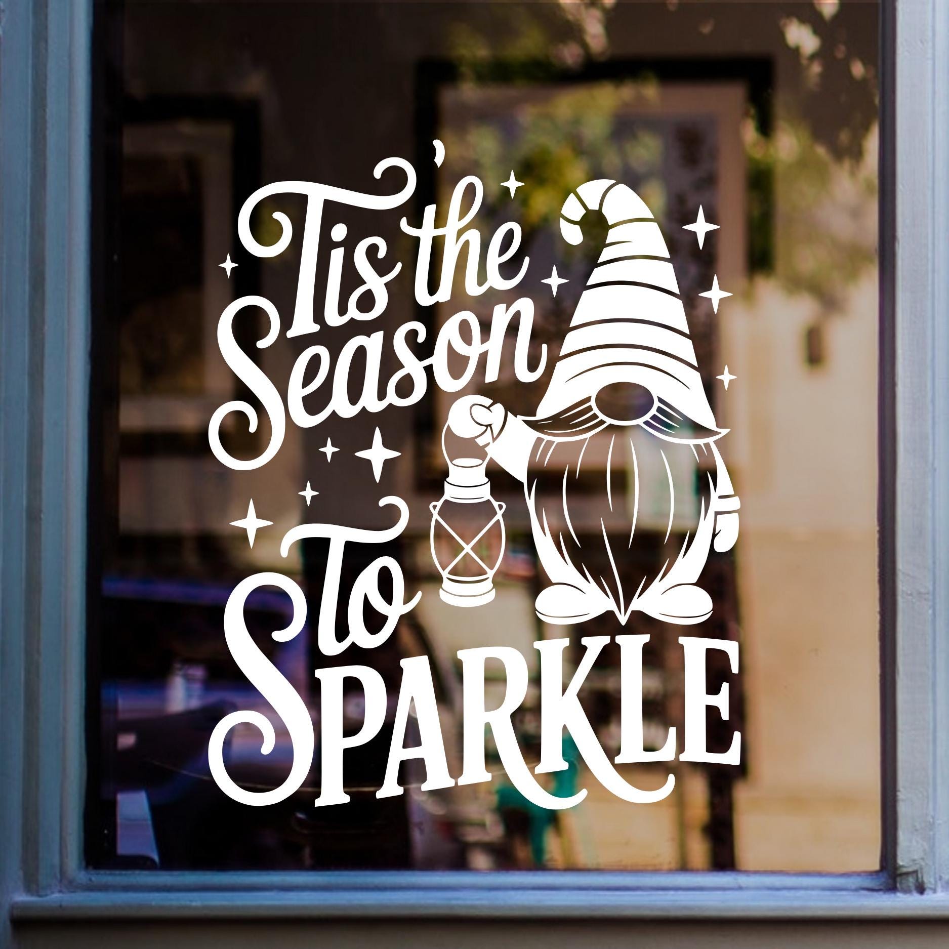 Tis the Season to Sparkle Christmas gnome window sticker displayed in white vinyl on glass.