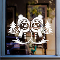 Christmas snowmen window sticker featuring two festive snowmen with winter hats, scarves and fir trees on glass.