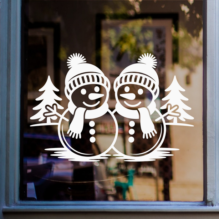 Christmas snowmen window sticker featuring two festive snowmen with winter hats, scarves and fir trees on glass.