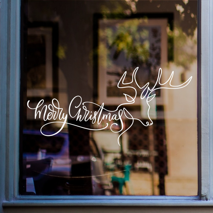 White Merry Christmas continuous-line reindeer window sticker displayed on a blue-framed shop window