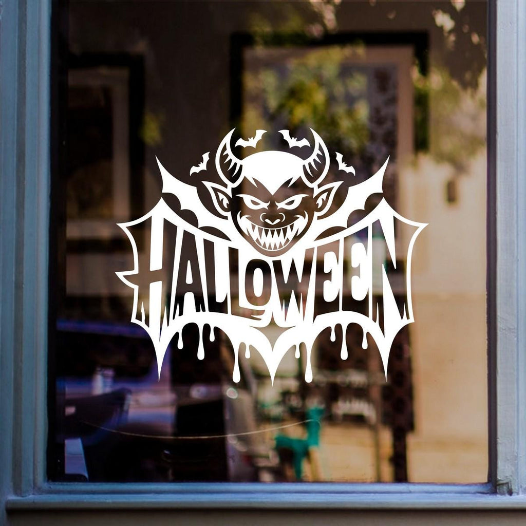 Grinning Devil & Bats Halloween Window Sticker: white vinyl design on a blue-framed glass door
