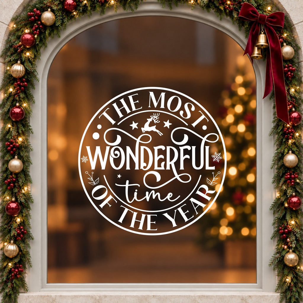 Round Most Wonderful Time of the Year Window Sticker in white on an arched cream window with a Christmas garland and red bow