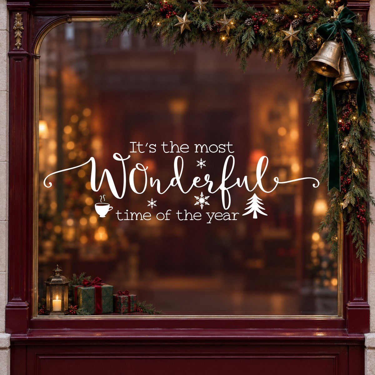 Wonderful Time of the Year Christmas Window Sticker in white on a burgundy shop window with festive greenery, bells and gifts