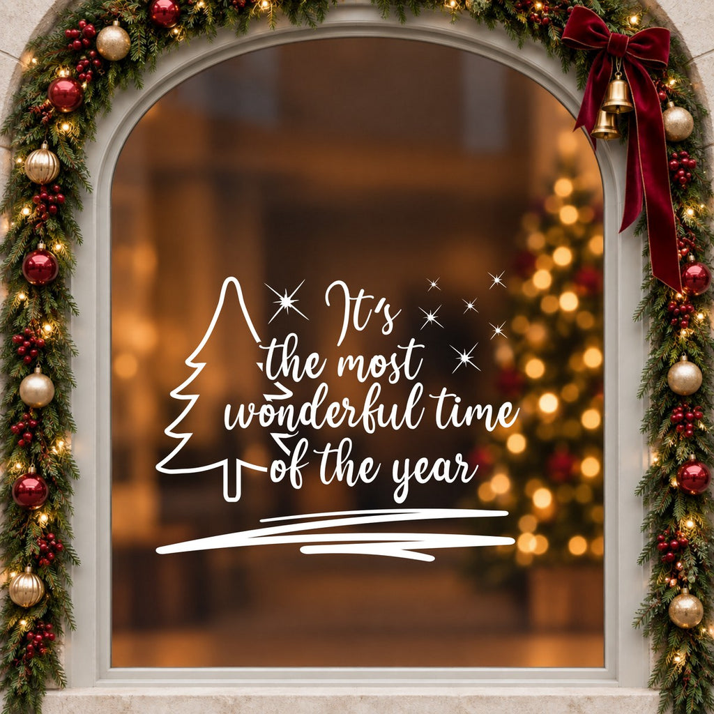 Wonderful Time of the Year Tree Window Sticker in white on an arched cream window with a Christmas garland and red bow