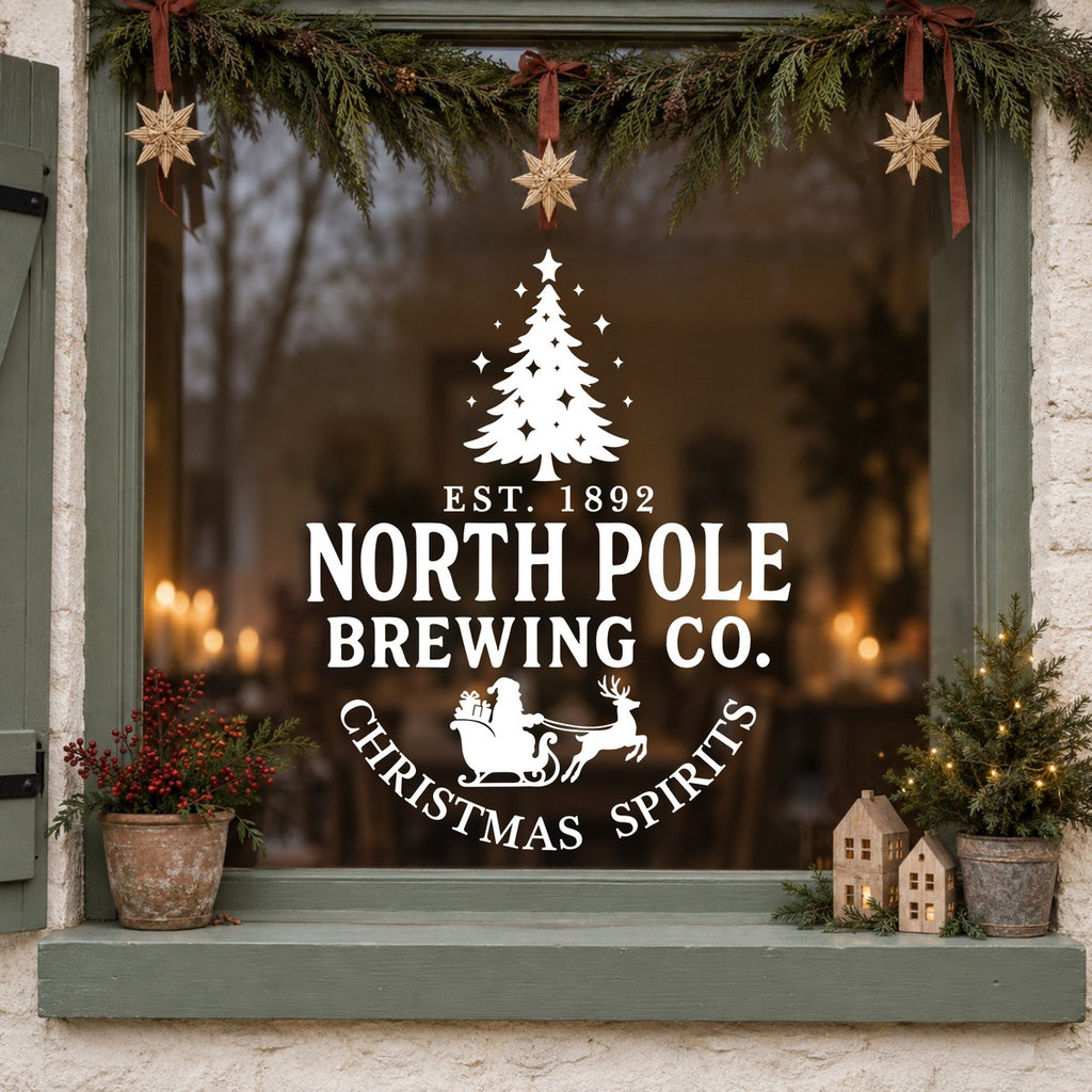 North Pole Brewing Co Christmas Window Sticker in white on a sage green framed window decorated for Christmas