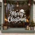 Merry Christmas Santa Hat Window Sticker in white on a sage green framed window decorated for Christmas