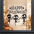 Dancing Skeletons Happy Halloween window sticker showing three dancing skeletons beneath Happy Halloween lettering, black vinyl on a light shop window with a dark charcoal frame