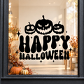Pumpkins Happy Halloween window sticker showing three jack-o’-lantern pumpkins above bold Happy Halloween lettering, black vinyl on a light shop window with a dark charcoal frame