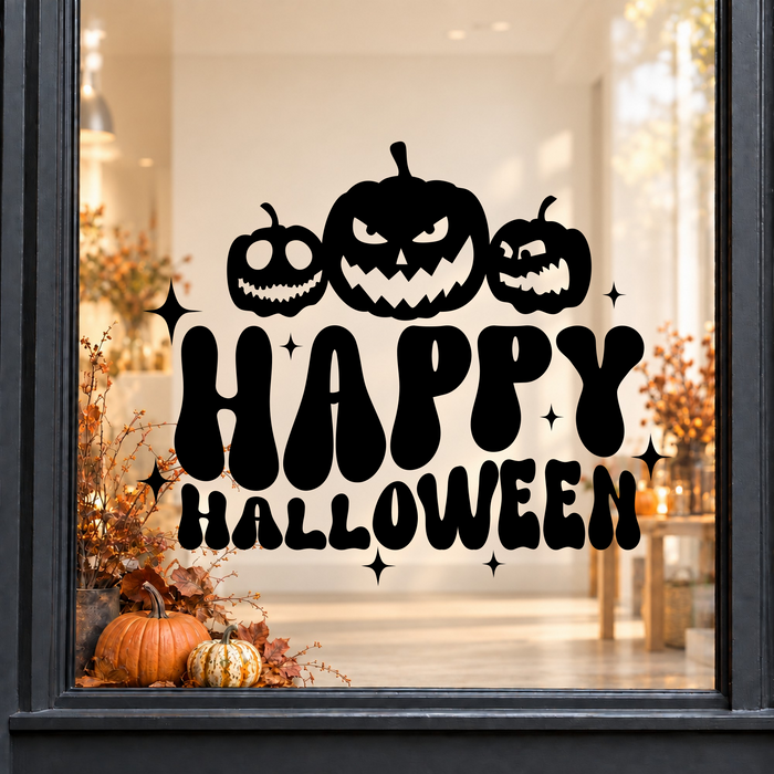 Pumpkins Happy Halloween window sticker showing three jack-o’-lantern pumpkins above bold Happy Halloween lettering, black vinyl on a light shop window with a dark charcoal frame