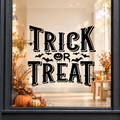 Trick or Treat Bats window sticker showing bold Trick or Treat lettering with small bats and Halloween flourishes, black vinyl on a light shop window with a dark charcoal frame