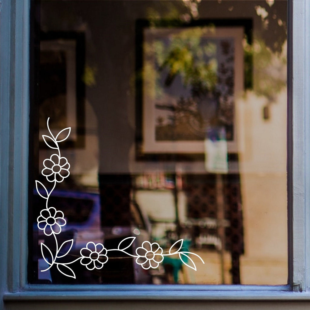 Floral Vine Corner Window Sticker for Shops & Homes displayed on a shop window