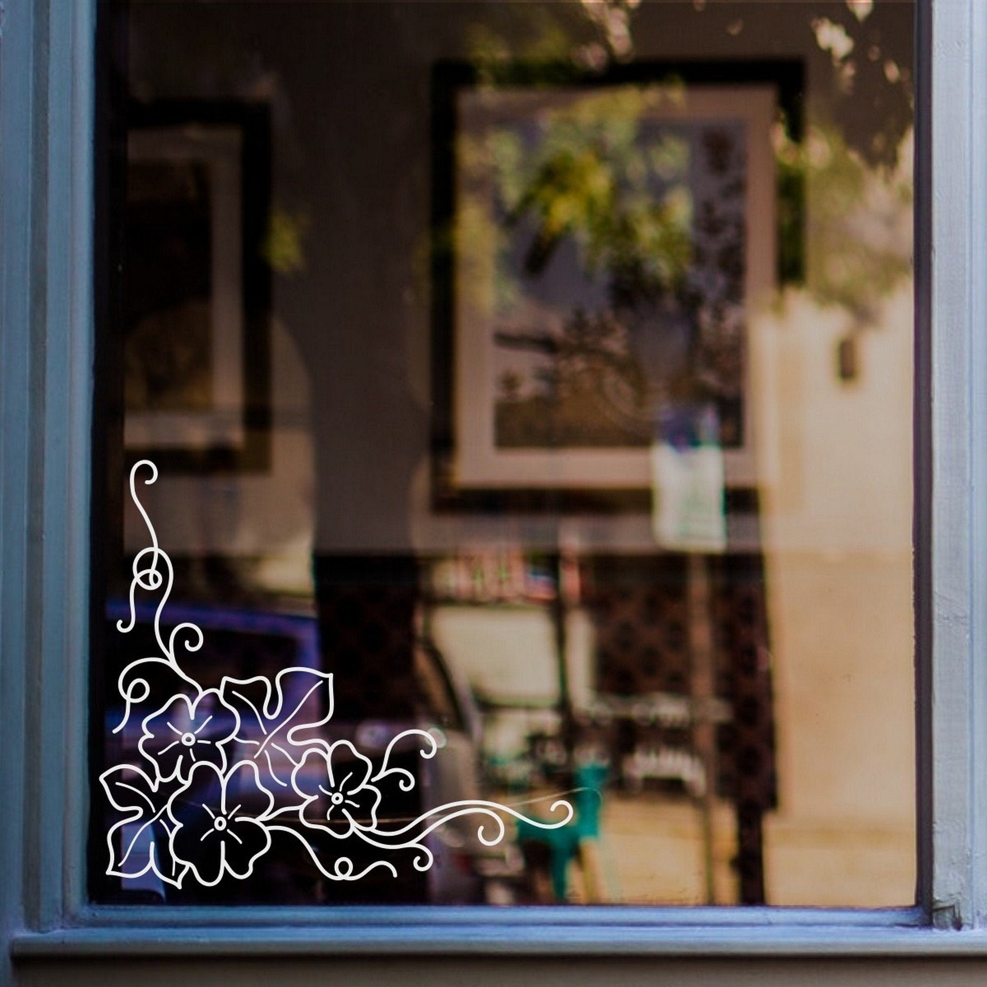 Floral Swirl Corner Window Sticker for Shops & Homes displayed on a shop window