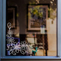 Daisy Floral Corner Window Sticker for Shops & Homes displayed on a shop window
