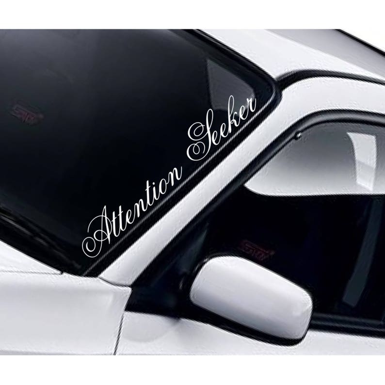 Attention Seeker white vinyl windscreen sticker fitted to a car