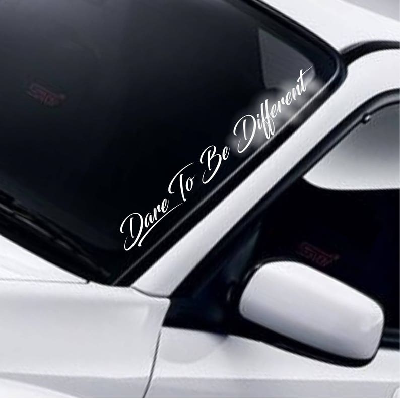 Dare To Be Different white vinyl windscreen sticker fitted to a car