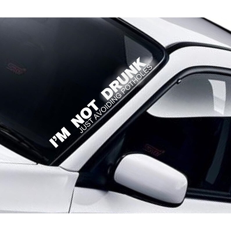 I'm Not Drunk Just Avoiding Potholes white vinyl windscreen sticker fitted to a car