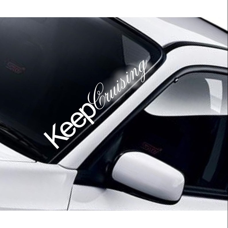 Keep Cruising white vinyl windscreen sticker fitted to a car
