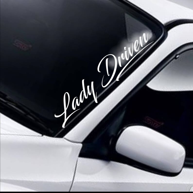 Lady Driven script white vinyl windscreen sticker fitted to a car