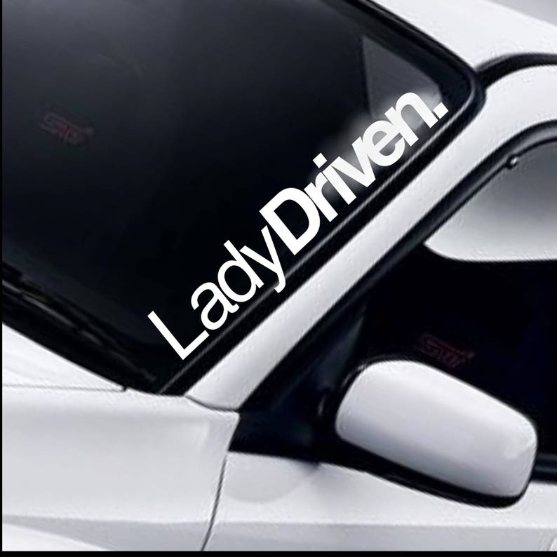 Lady Driven bold white vinyl windscreen sticker fitted to a car