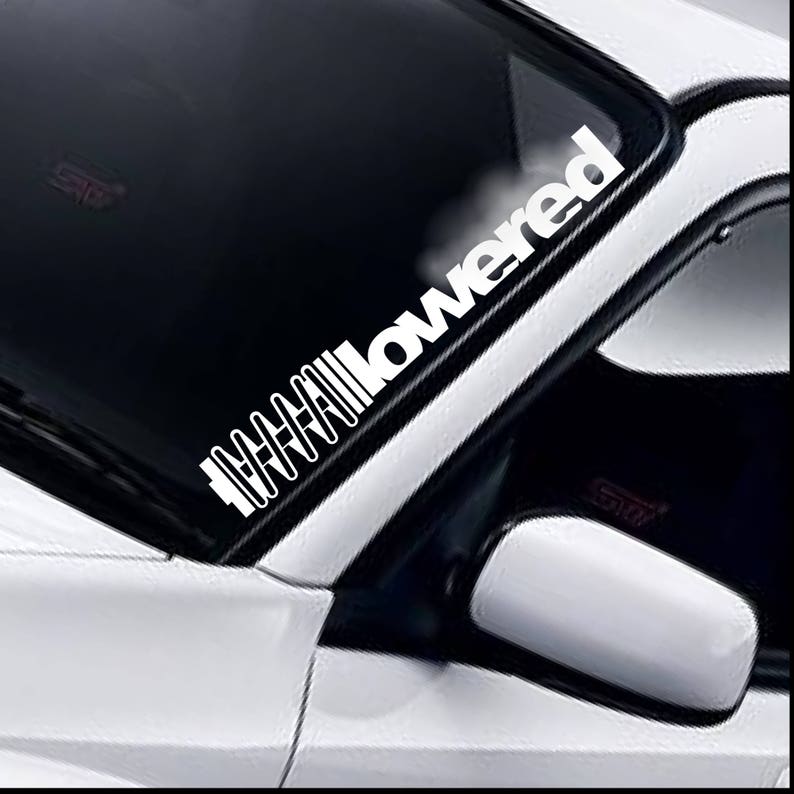 Lowered coil windscreen sticker fitted to a car windscreen