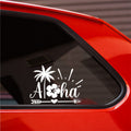 White Aloha palm tree and hibiscus sticker on a red car's rear side window.