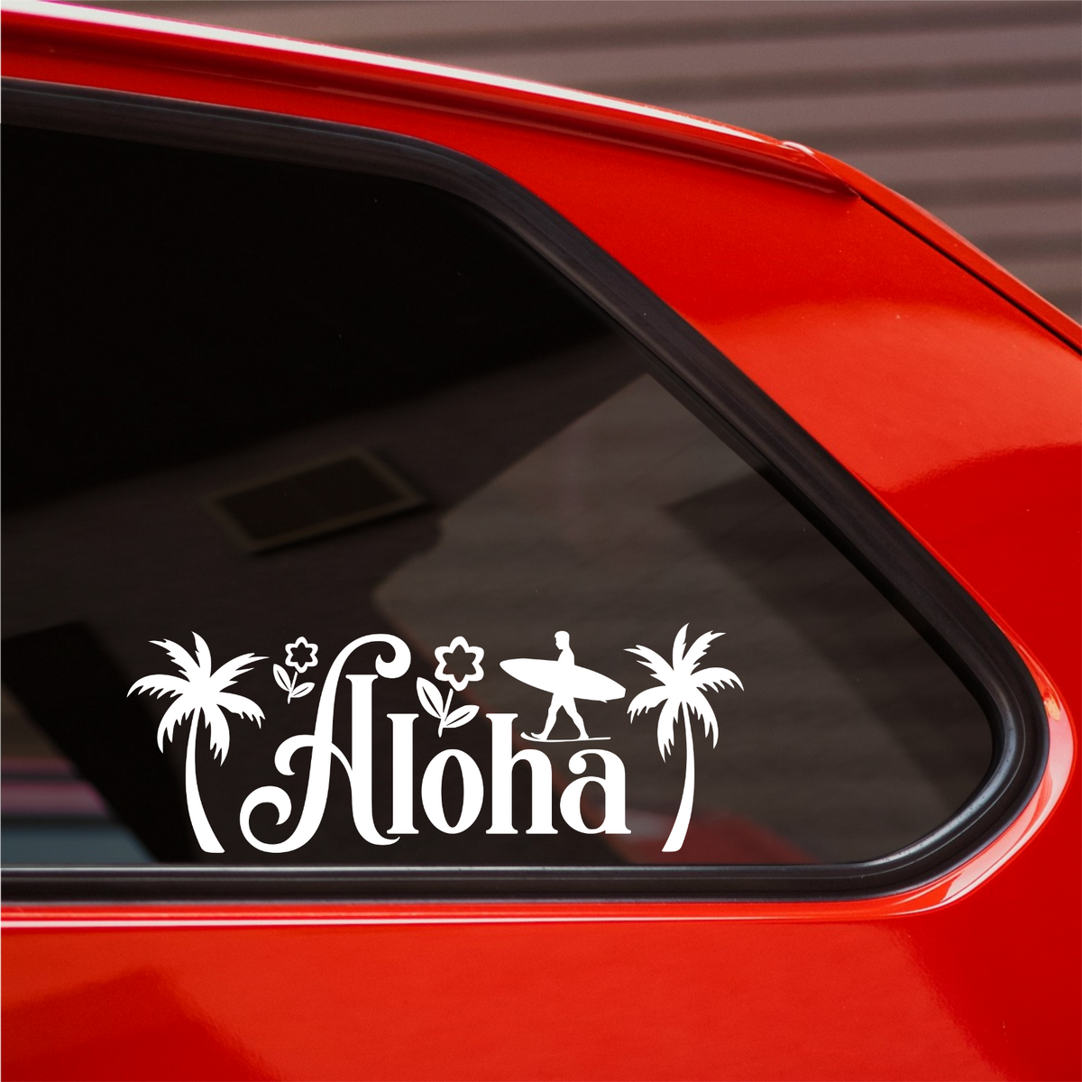 White Aloha surf decal on the rear side window of a red car.