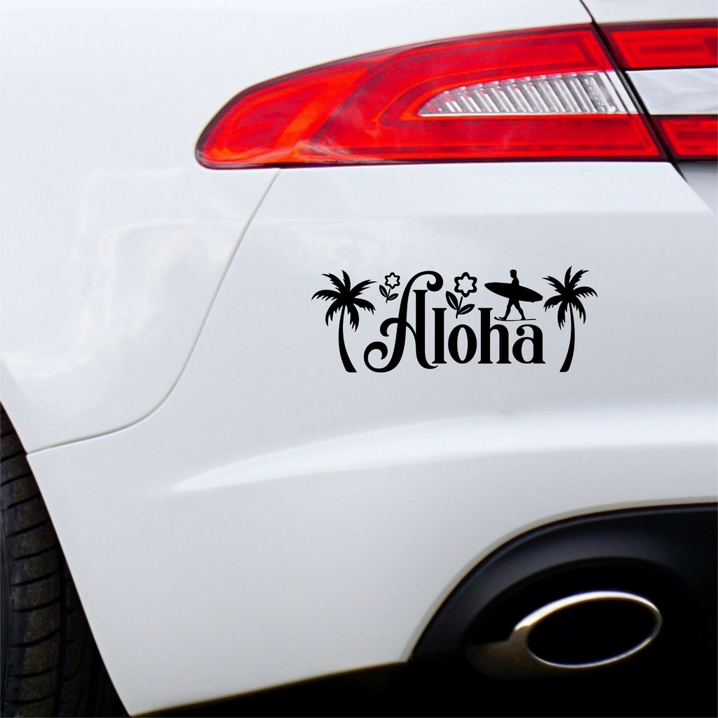Black Aloha surf sticker on the rear bumper of a white car.