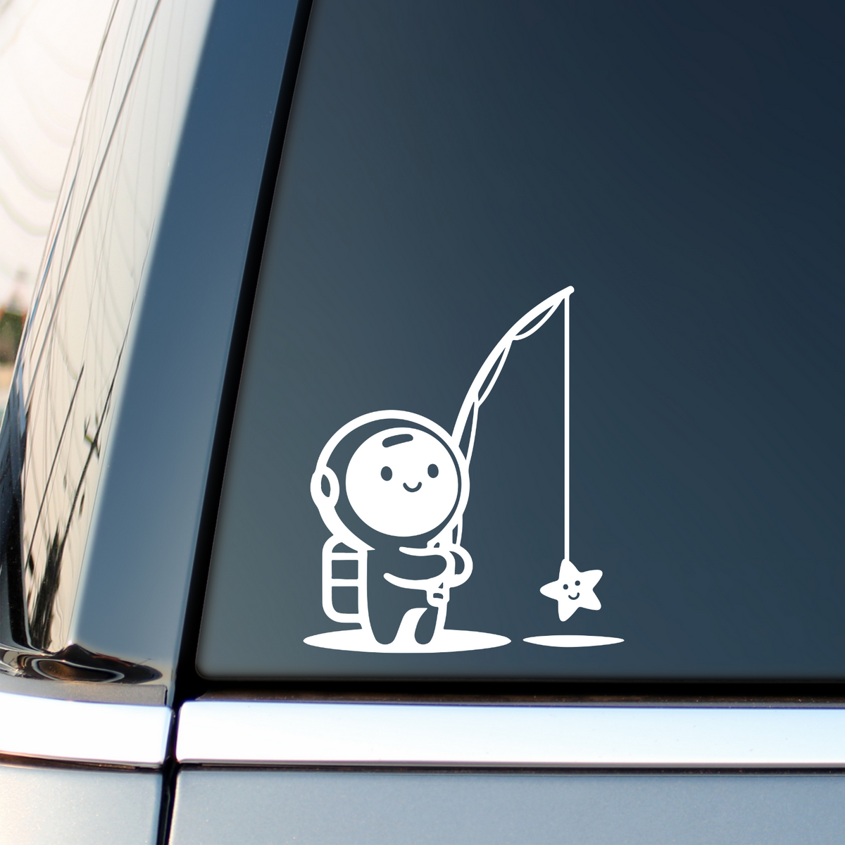 White astronaut fishing for a star decal on a vehicle side window.