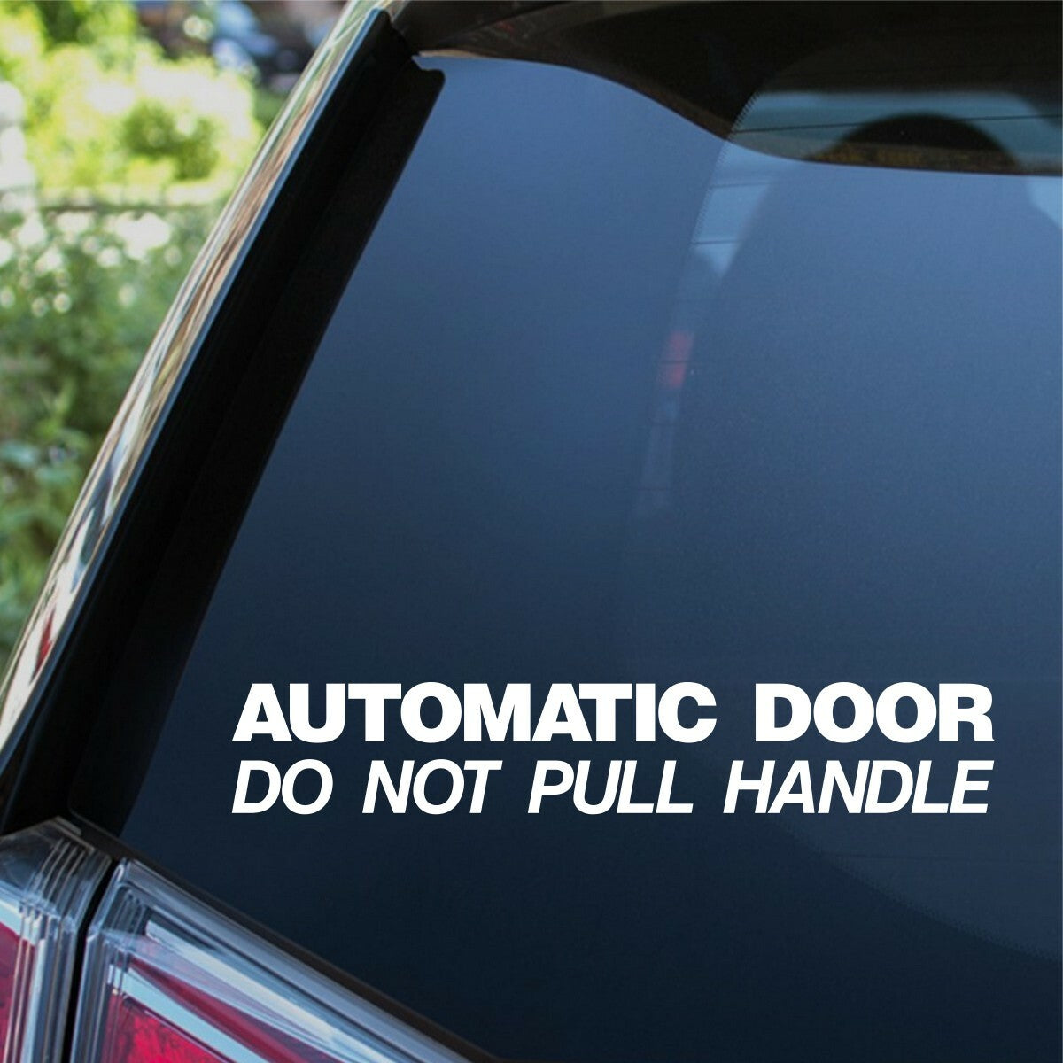 White Automatic Door Do Not Pull Handle sticker on a vehicle window.