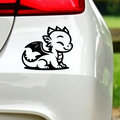 Black baby dragon sticker on white car bodywork.