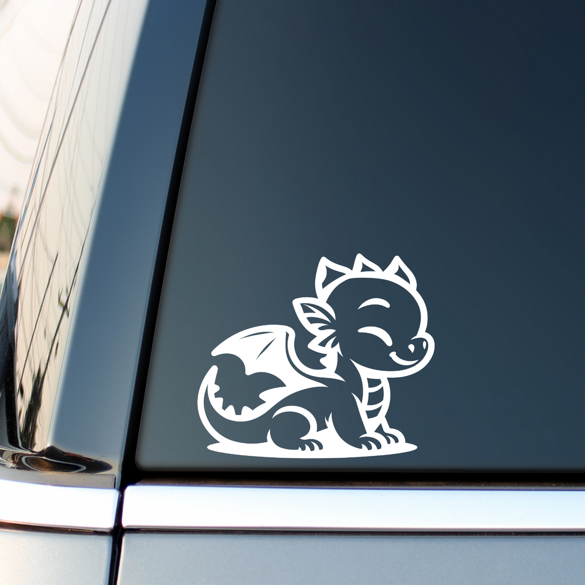 White baby dragon decal on a vehicle side window.