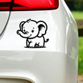 Black baby elephant sticker on white car bodywork.