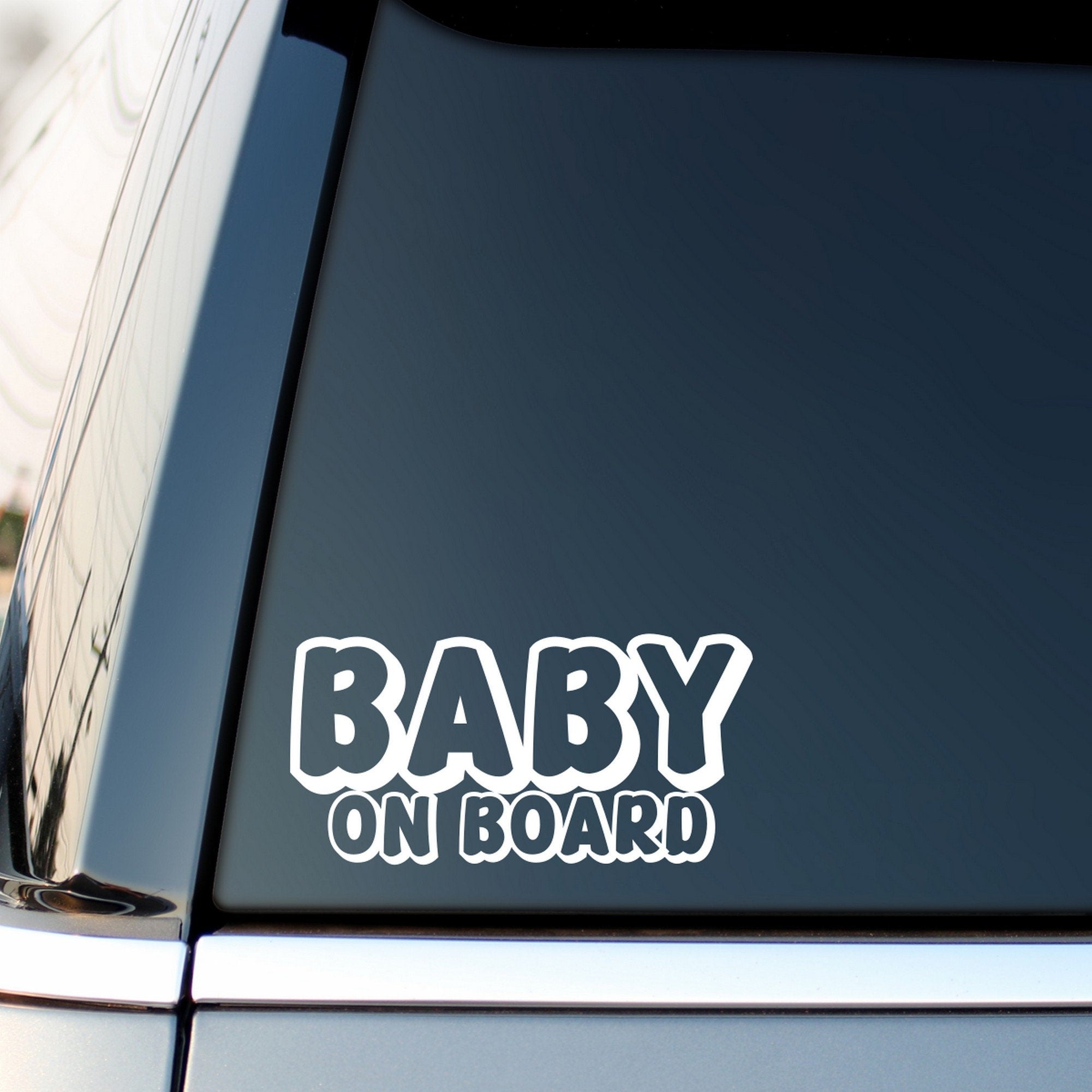Baby On Board outline car sticker shown on a vehicle rear window